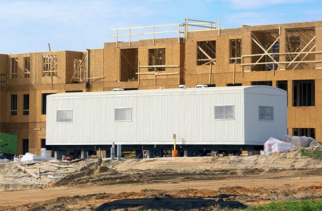 workers studying blueprints in a temporary rental office in Lake Milton